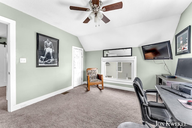 office area with baseboards, visible vents, a ceiling fan, carpet, and vaulted ceiling