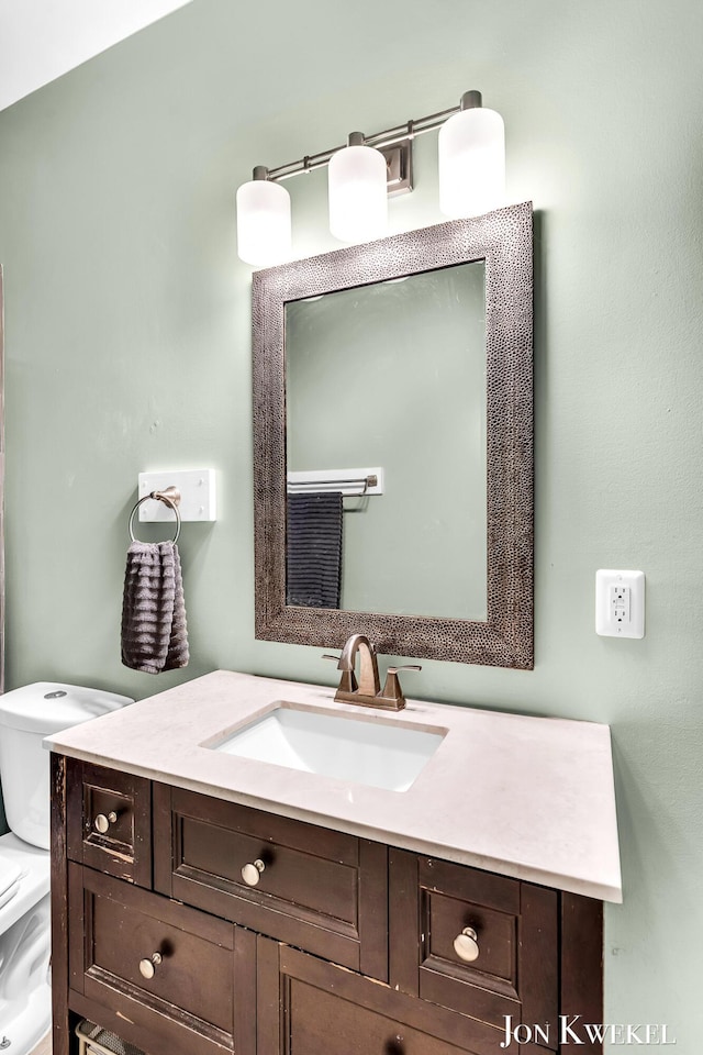 bathroom featuring toilet and vanity