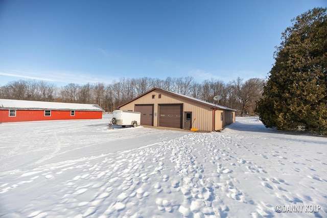 snow covered structure featuring an outdoor structure