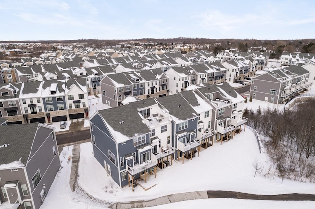 snowy aerial view featuring a residential view