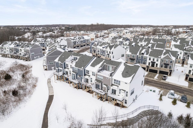 snowy aerial view with a residential view