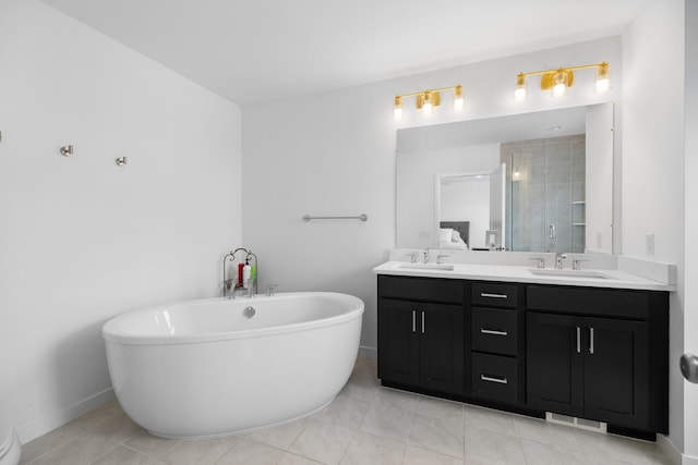 bathroom featuring double vanity, a soaking tub, a sink, and a shower stall