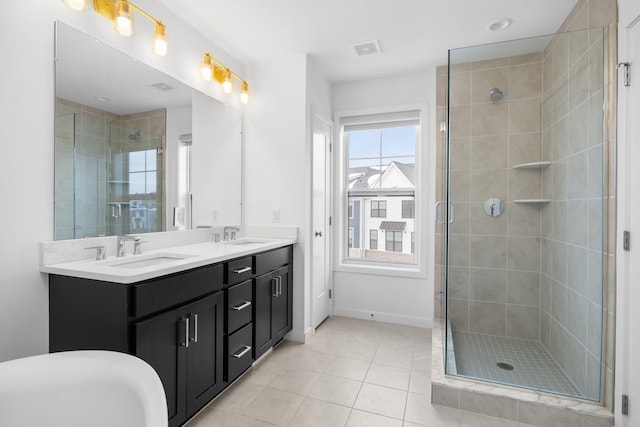 full bath featuring tile patterned flooring, a sink, visible vents, a shower stall, and double vanity