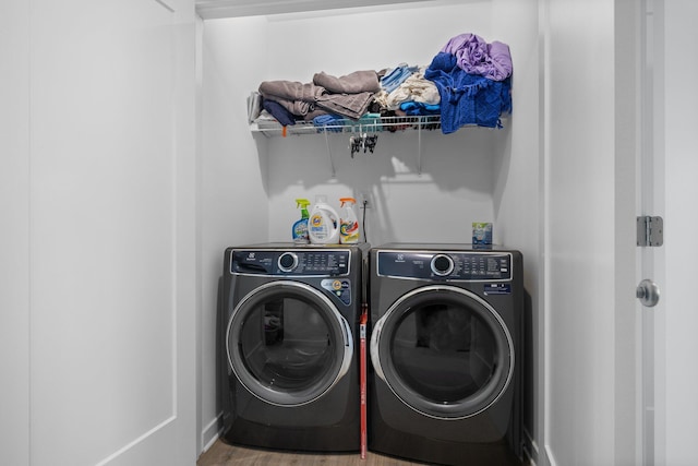 laundry room featuring laundry area, independent washer and dryer, and wood finished floors