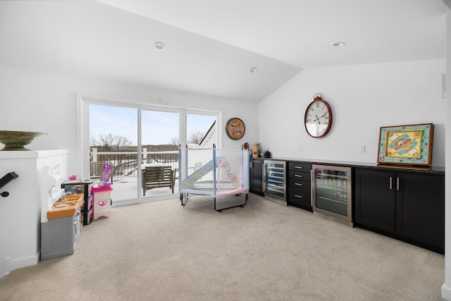 sitting room featuring vaulted ceiling, a bar, wine cooler, and light carpet