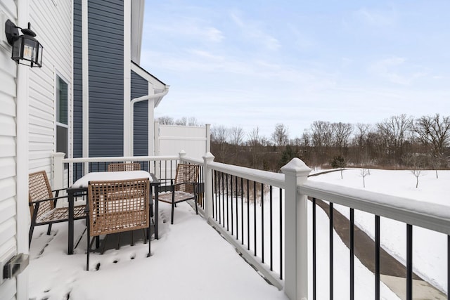 view of snow covered back of property