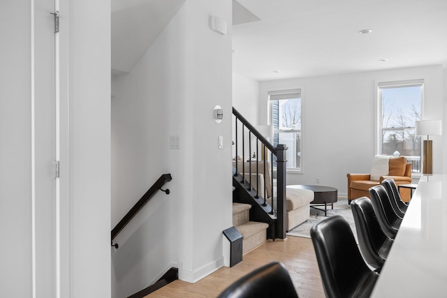 stairs featuring baseboards and wood finished floors