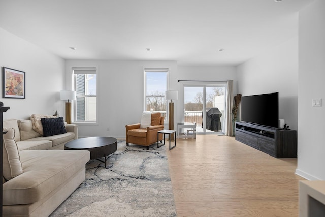 living room featuring light wood-style flooring and baseboards