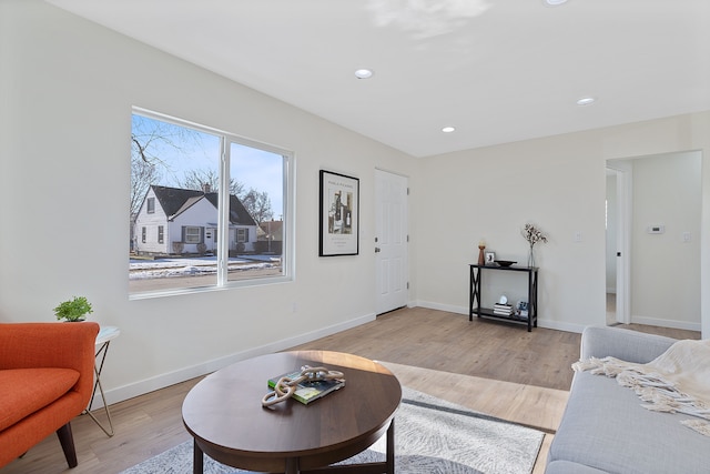 living area with light wood finished floors, recessed lighting, and baseboards