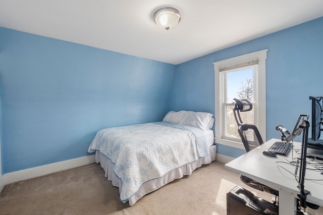 bedroom with baseboards and light carpet