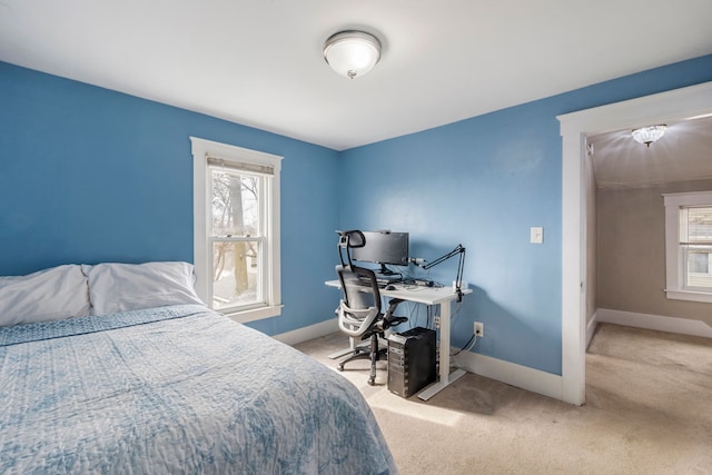 carpeted bedroom featuring baseboards