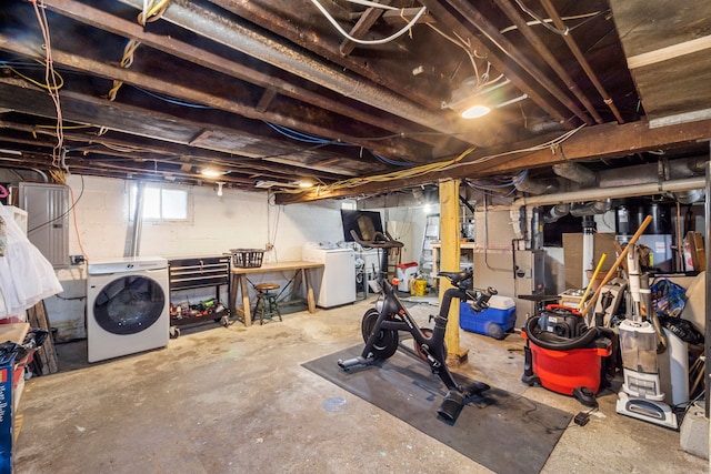 below grade area featuring washing machine and clothes dryer