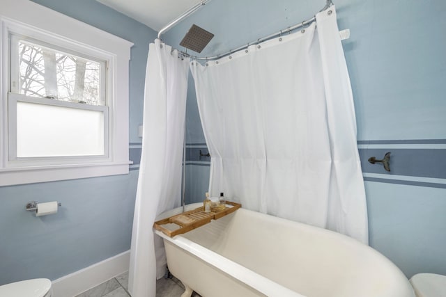 bathroom with toilet and baseboards