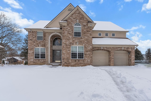 traditional home featuring an attached garage and brick siding