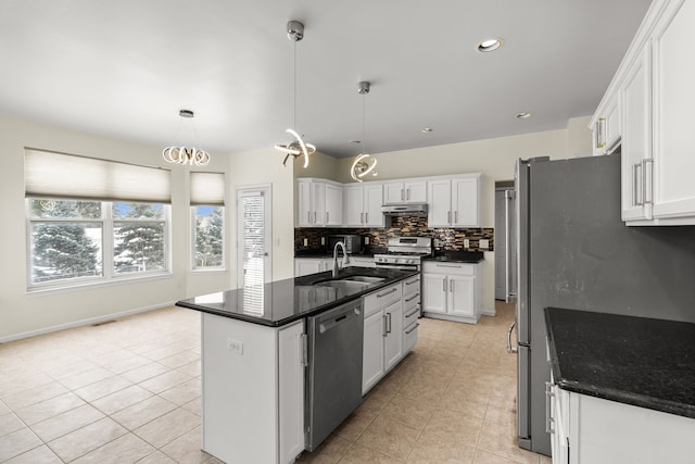 35316 Burgundy, Sterling Heights, MI 48312 - kitchen with appliances with stainless steel finishes, dark countertops, white cabinetry, and a kitchen island with sink