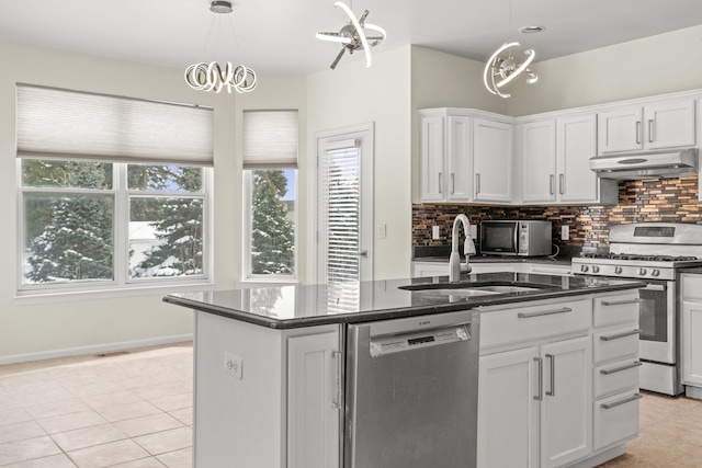 35316 Burgundy, Sterling Heights, MI 48312 - kitchen featuring appliances with stainless steel finishes, dark countertops, white cabinets, and under cabinet range hood
