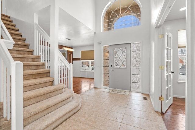 35316 Burgundy, Sterling Heights, MI 48312 - entryway with light tile patterned floors, stairway, visible vents, and baseboards