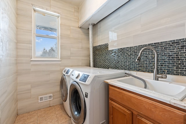 35316 Burgundy, Sterling Heights, MI 48312 - washroom with light tile patterned floors, cabinet space, visible vents, washer and clothes dryer, and a sink