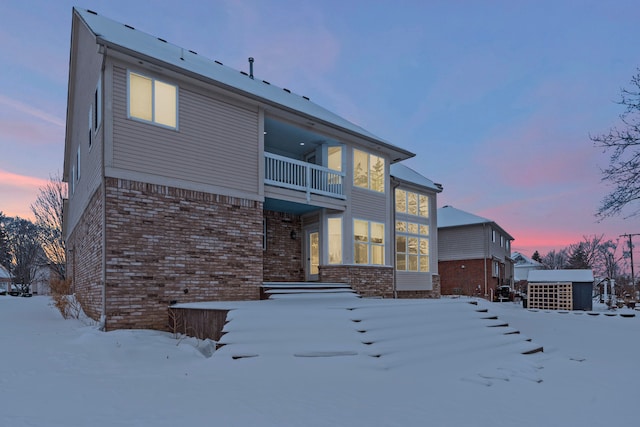 35316 Burgundy, Sterling Heights, MI 48312 - snow covered property with a balcony and brick siding