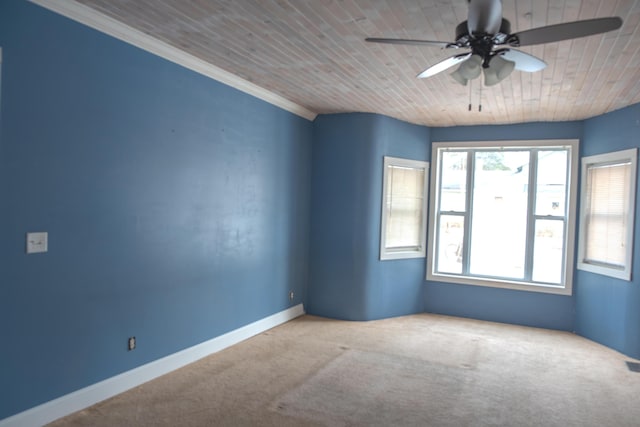 unfurnished room with carpet floors, wooden ceiling, baseboards, and a ceiling fan