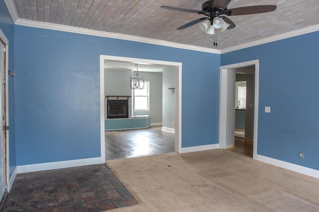 unfurnished room with baseboards, ornamental molding, and a fireplace with raised hearth