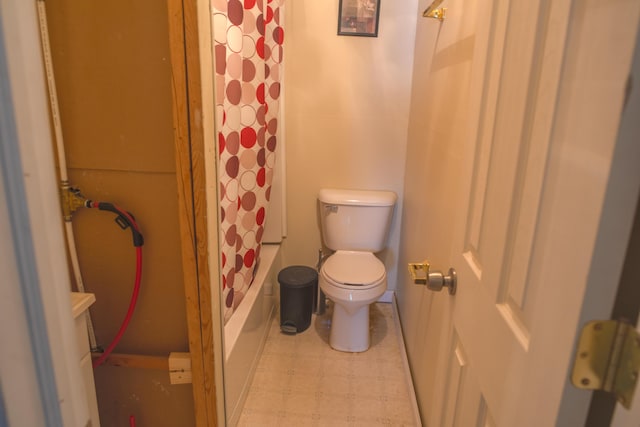 full bath featuring toilet, shower / tub combo, and tile patterned floors