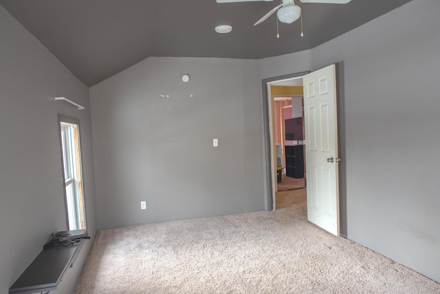 unfurnished room with vaulted ceiling, carpet floors, and ceiling fan