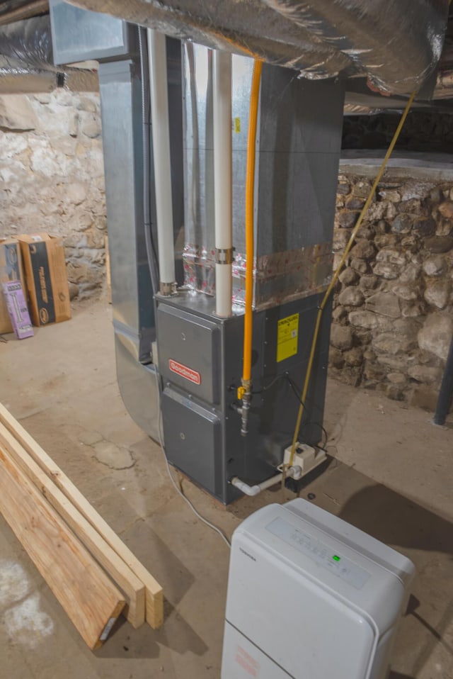 utility room featuring heating unit