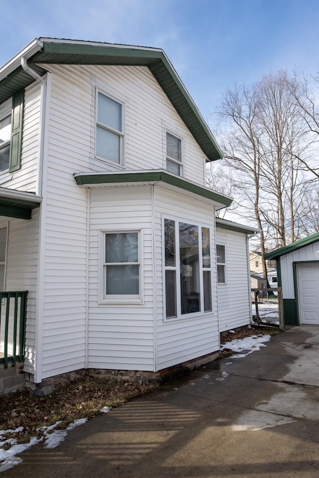 view of side of home with a garage and an outdoor structure