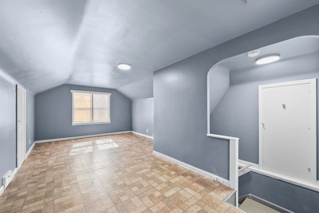 bonus room featuring visible vents, vaulted ceiling, and baseboards