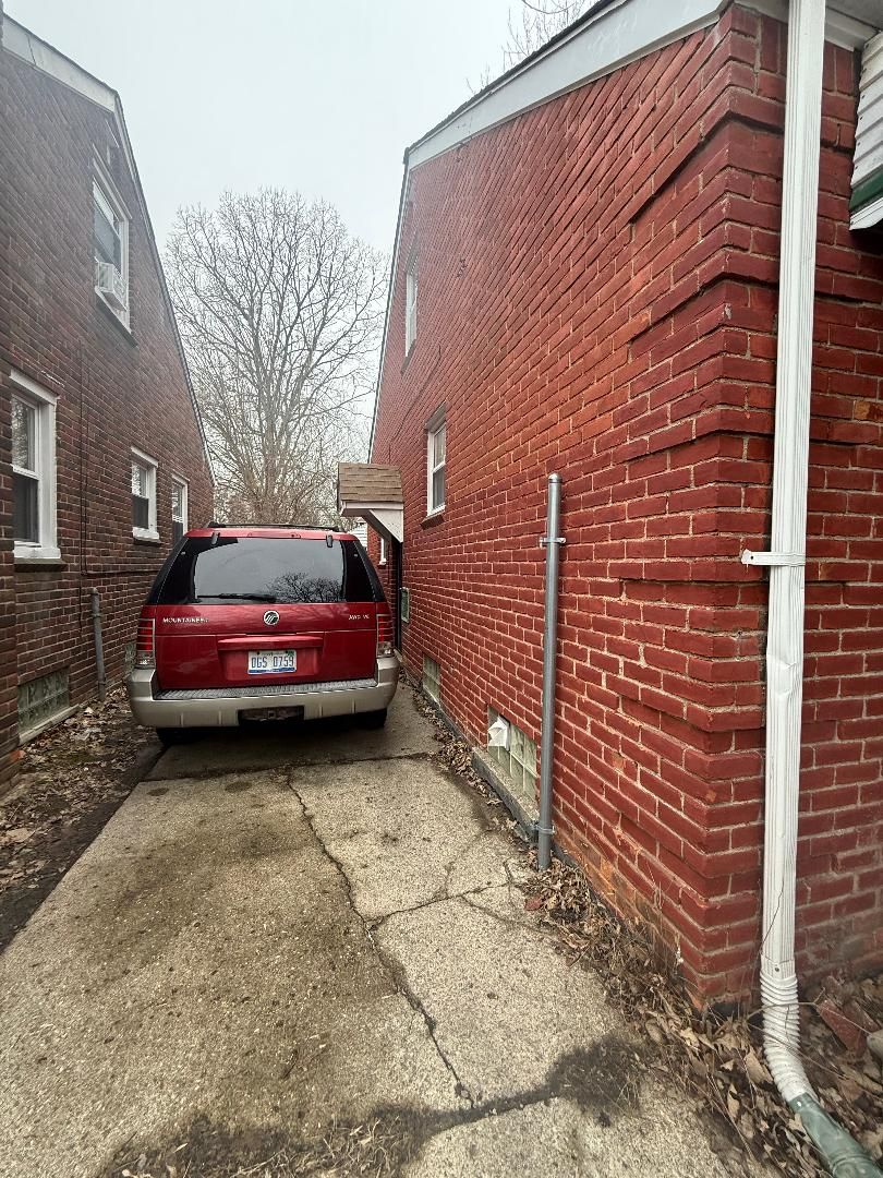 view of side of home featuring brick siding