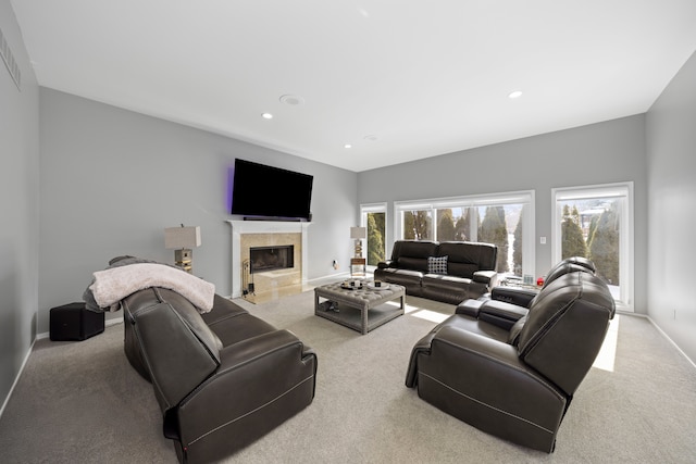 living room featuring plenty of natural light, carpet, a fireplace, and baseboards