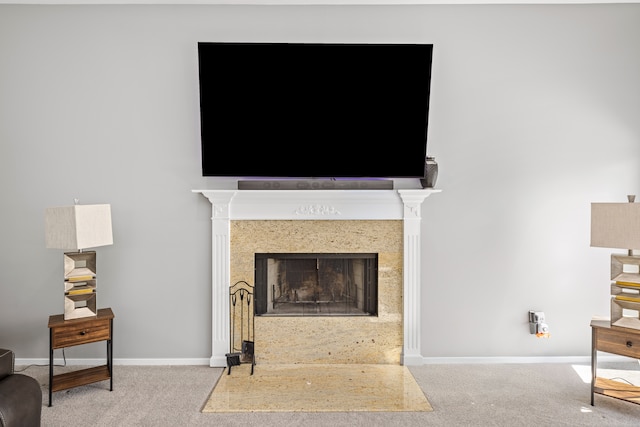 interior details featuring carpet floors, baseboards, and a fireplace with flush hearth