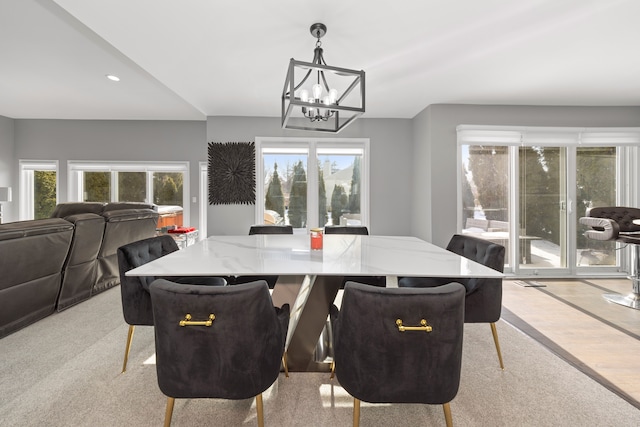 dining room with a wealth of natural light and an inviting chandelier