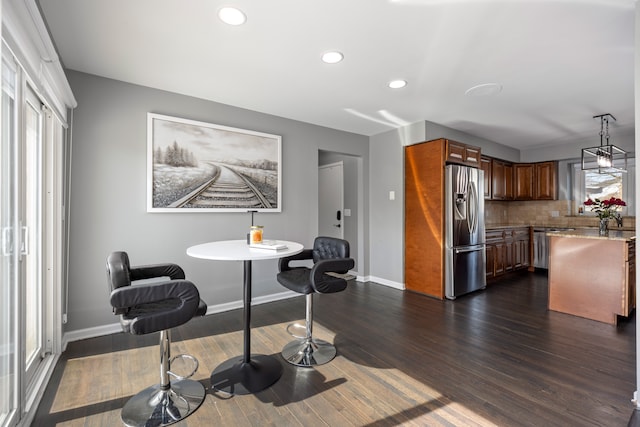 dining space featuring dark wood-style floors, recessed lighting, and baseboards