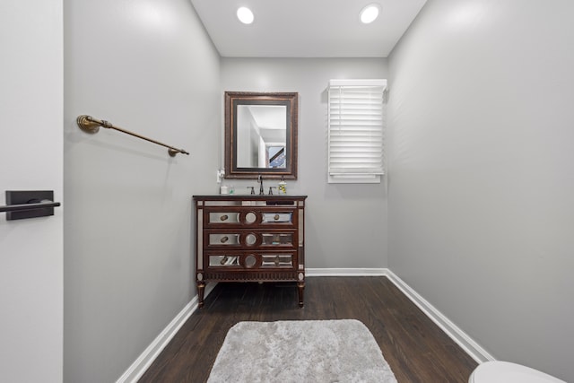 interior space with recessed lighting, wood finished floors, vanity, and baseboards