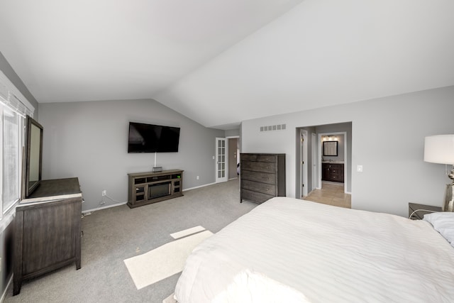 bedroom with lofted ceiling, baseboards, visible vents, and light colored carpet