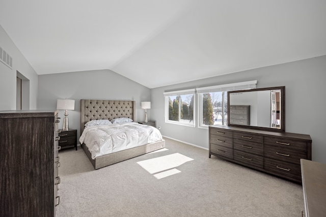 bedroom with light carpet, vaulted ceiling, visible vents, and baseboards