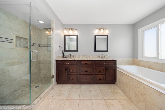 full bath with a stall shower, double vanity, a sink, and a bath