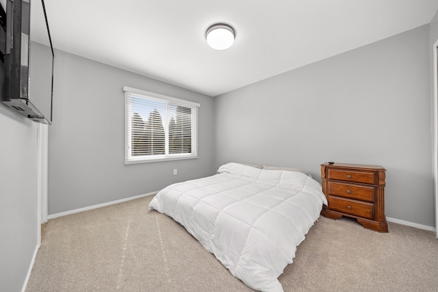 carpeted bedroom with baseboards