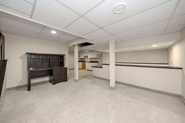 finished basement featuring baseboards, recessed lighting, a paneled ceiling, and light colored carpet