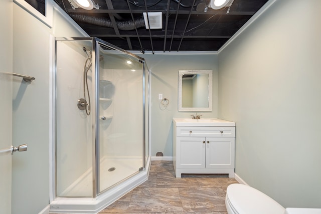 bathroom featuring visible vents, a stall shower, vanity, and toilet