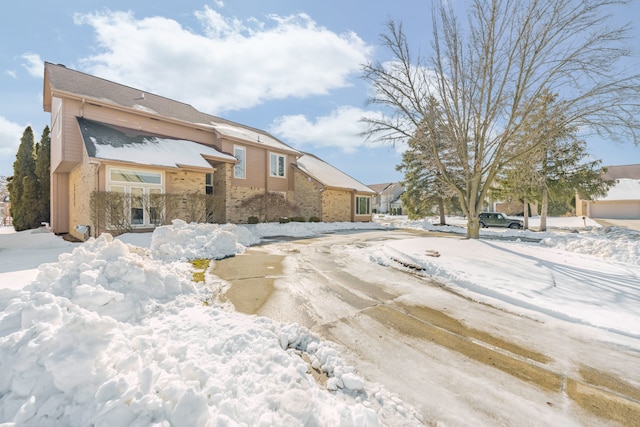 view of snow covered rear of property