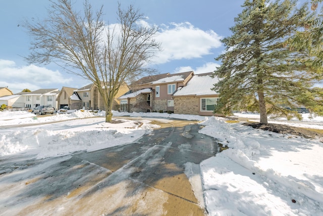 view of front of home with brick siding and a residential view