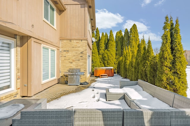 view of patio / terrace with a hot tub and a grill