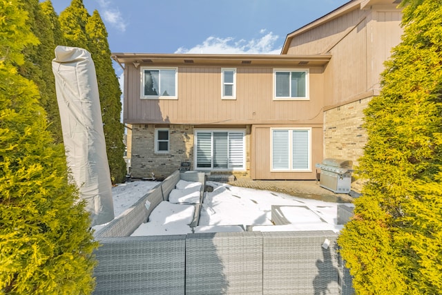 rear view of property featuring a patio area and outdoor lounge area