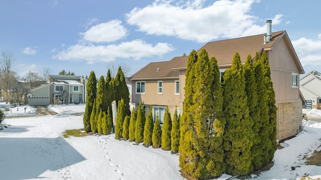 view of snowy exterior with a residential view