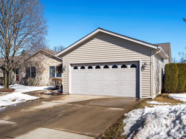 single story home featuring a garage and concrete driveway