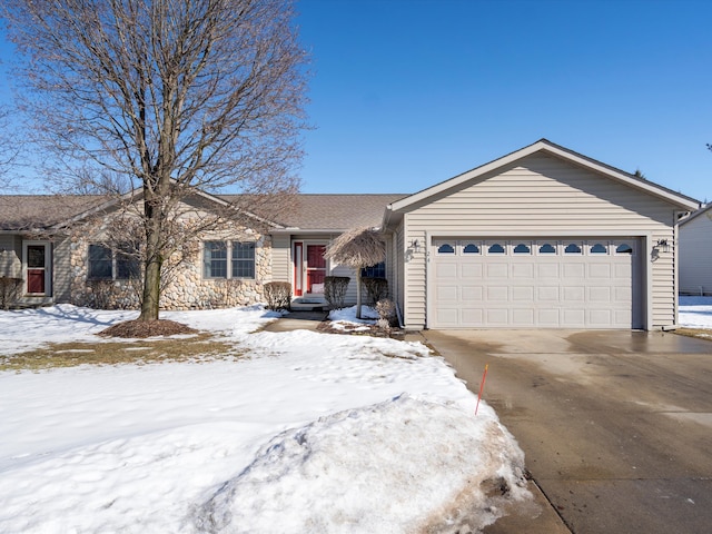 ranch-style home with driveway, stone siding, and an attached garage