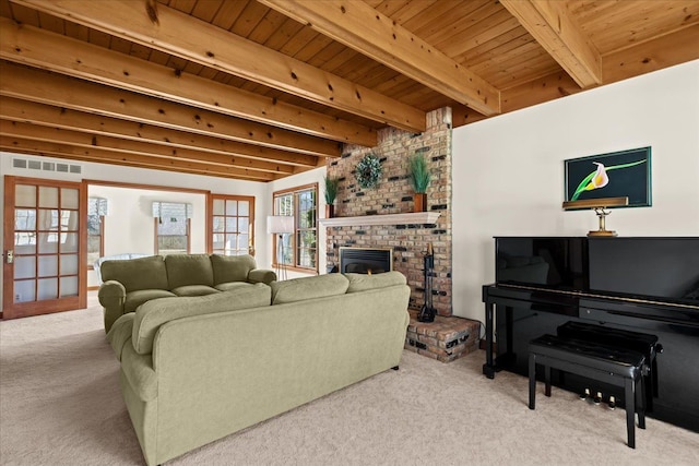 living area featuring visible vents, beamed ceiling, carpet, wooden ceiling, and a fireplace